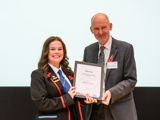 A photo of a pupil receiving her award at the BNF Annual Conference