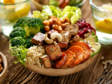 vegan buddha bowl, containing sweet potato, couscous, broccoli and other vegetables