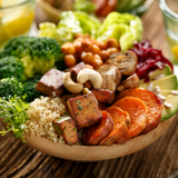 vegan buddha bowl, containing sweet potato, couscous, broccoli and other vegetables